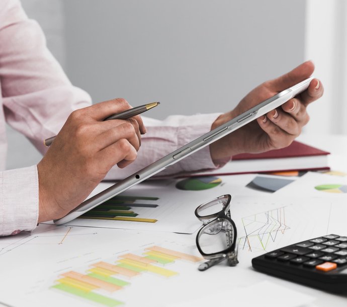 man crunching numbers on a tablet